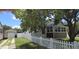 Fenced backyard with lush tree providing shade; detached garage and additional sunroom for extra space at 3131 Melton N St, St Petersburg, FL 33704