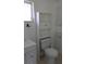 Bathroom featuring a toilet with built-in shelving, a vanity, and a window at 3131 Melton N St, St Petersburg, FL 33704