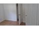 Bright bedroom with wood-look floors, white trim and walls, plus multiple doors leading to other rooms at 3131 Melton N St, St Petersburg, FL 33704