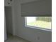 Cozy bedroom with a window view, neutral tile flooring and plenty of natural light at 3131 Melton N St, St Petersburg, FL 33704