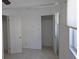 Bedroom featuring neutral tile, a closet, and bright natural light at 3131 Melton N St, St Petersburg, FL 33704