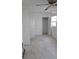 A spacious bedroom featuring neutral tile flooring, a closet, a ceiling fan, and an exterior window at 3131 Melton N St, St Petersburg, FL 33704