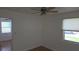 Bright bedroom showcasing hardwood floors, ceiling fan, and ample natural light at 3131 Melton N St, St Petersburg, FL 33704