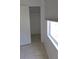 View of a bedroom closet with white walls and tile flooring, plus an exterior window with closed blinds at 3131 Melton N St, St Petersburg, FL 33704