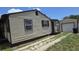Charming single-story home with horizontal siding, shutters, and a well-maintained driveway, leading to the detached garage at 3131 Melton N St, St Petersburg, FL 33704