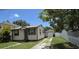 Cozy single-Gathering home featuring neutral siding, a well-maintained lawn, and a detached single-car garage at 3131 Melton N St, St Petersburg, FL 33704