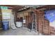 View of the garage interior with an assortment of tools, ladders, household items and overhead storage at 3131 Melton N St, St Petersburg, FL 33704