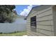 View of the detached garage in the backyard and white fence separating the properties at 3131 Melton N St, St Petersburg, FL 33704