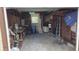View of the garage interior with an assortment of tools, ladders, and household items and '32 AV N' sign on the wall at 3131 Melton N St, St Petersburg, FL 33704