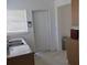Kitchen featuring stainless-steel sink, laminate countertops, and tan cabinets on tile flooring at 3131 Melton N St, St Petersburg, FL 33704