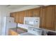 Kitchen boasting wooden cabinets, granite countertops, and modern appliances for seamless cooking experiences at 3131 Melton N St, St Petersburg, FL 33704