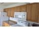 Kitchen boasting wooden cabinets, granite countertops, and modern appliances for seamless cooking experiences at 3131 Melton N St, St Petersburg, FL 33704