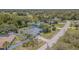 Expansive aerial view showcases the house with mature trees and the surrounding neighborhood at 3144 Abeline Rd, Spring Hill, FL 34608