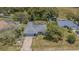 Overhead shot captures the home's layout, backyard, and proximity to the road and surrounding greenery at 3144 Abeline Rd, Spring Hill, FL 34608