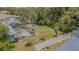 Aerial view showcases the backyard with an enclosed patio, mature trees, and fenced property line at 3144 Abeline Rd, Spring Hill, FL 34608