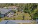 Aerial shot captures the home's backyard with an enclosed patio area and privacy fence at 3144 Abeline Rd, Spring Hill, FL 34608