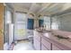 Bright bathroom featuring a shower, toilet, mirror, and vanity sink at 3144 Abeline Rd, Spring Hill, FL 34608