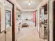 Bathroom showing pink sink, tiled tub, open storage area, and mirrored closet at 3144 Abeline Rd, Spring Hill, FL 34608