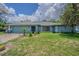 Charming single-story home with a well-manicured front yard and a two-car garage at 3144 Abeline Rd, Spring Hill, FL 34608