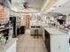 Kitchen with white countertops, appliances, island and view of adjoining rooms at 3144 Abeline Rd, Spring Hill, FL 34608