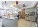 Open kitchen featuring a center island, tile floors, and generous natural light at 3144 Abeline Rd, Spring Hill, FL 34608