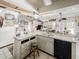 Kitchen featuring white cabinetry, peninsula countertop, tile flooring and ample storage at 3144 Abeline Rd, Spring Hill, FL 34608