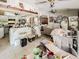 Open living area showing kitchen and seating areas with tile flooring and ceiling fans at 3144 Abeline Rd, Spring Hill, FL 34608