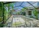Outdoor pool with screen and green foliage at 3144 Abeline Rd, Spring Hill, FL 34608