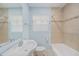 Bathroom featuring tile surround bathtub, neutral walls, and a vanity with a large mirror at 3205 68Th N Ave, St Petersburg, FL 33702