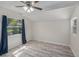 Bright bedroom with sloped ceiling, wood-look flooring, a ceiling fan, and a large window at 3205 68Th N Ave, St Petersburg, FL 33702