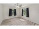 Bright bedroom with two windows, modern ceiling fan, and wood-look flooring throughout at 3205 68Th N Ave, St Petersburg, FL 33702