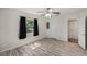 Well-lit bedroom with wood-look floors, a ceiling fan, and a window overlooking the yard at 3205 68Th N Ave, St Petersburg, FL 33702