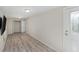 Bonus room features wood-look floors, neutral walls, and recessed lighting with an exterior door at 3205 68Th N Ave, St Petersburg, FL 33702