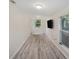 Large bonus room with recessed lighting, wood-look flooring, and natural light from two windows at 3205 68Th N Ave, St Petersburg, FL 33702
