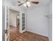 Bright dining area featuring wood floors, a ceiling fan, and glass paneled doors to the adjacent kitchen at 3205 68Th N Ave, St Petersburg, FL 33702