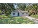 Charming single-story home featuring a well-manicured lawn and mature trees, offering great curb appeal at 3205 68Th N Ave, St Petersburg, FL 33702