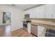 Modern kitchen with granite countertops, white cabinets, and stainless steel appliances at 3205 68Th N Ave, St Petersburg, FL 33702