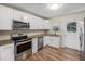 Updated kitchen featuring stainless steel appliances, granite countertops, and stylish white cabinetry at 3205 68Th N Ave, St Petersburg, FL 33702