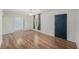 Bright living room featuring wood-look floors, a ceiling fan, and a stylish paneled door at 3205 68Th N Ave, St Petersburg, FL 33702