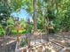 Charming backyard with decorative metal archway and lush greenery at 3506 Cordgrass Dr, Valrico, FL 33596