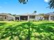 Spacious backyard with a well-manicured lawn and a view of the home's screened-in patio at 3506 Cordgrass Dr, Valrico, FL 33596
