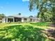 Expansive backyard featuring a large lawn, a screened-in patio, and mature trees for privacy at 3506 Cordgrass Dr, Valrico, FL 33596