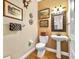 Charming half bathroom with decorative art, a pedestal sink, and elegant lighting at 3506 Cordgrass Dr, Valrico, FL 33596