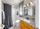Bright bathroom with granite countertops, patterned shower curtain, and modern fixtures at 3506 Cordgrass Dr, Valrico, FL 33596