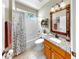 Charming bathroom with a shower-tub combination, wood-framed mirror, and granite countertops at 3506 Cordgrass Dr, Valrico, FL 33596