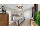Well-lit bedroom features a ceiling fan, large closet, stylish furnishings, and decorative wall art at 3506 Cordgrass Dr, Valrico, FL 33596