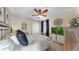 Inviting bedroom with ceiling fan, dresser with TV, comfortable bedding, and natural light at 3506 Cordgrass Dr, Valrico, FL 33596