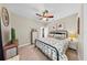 Comfortable bedroom with ceiling fan, decorative headboard, dresser with TV, and stylish furnishings at 3506 Cordgrass Dr, Valrico, FL 33596