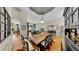 Spacious dining room with hardwood floors and views into the living room and front entryway at 3506 Cordgrass Dr, Valrico, FL 33596