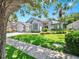 Well-maintained home with lush landscaping, a green lawn, and a classic American flag at 3506 Cordgrass Dr, Valrico, FL 33596